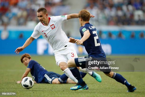 Poland is challengred by Gotoku Sakai of Japan during the 2018 FIFA World Cup Russia group H match between Japan and Poland at Volgograd Arena on...