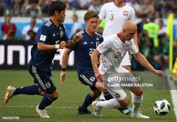 Japan's defender Hiroki Sakai vies with Poland's midfielder Rafal Kurzawa past Japan's defender Gotoku Sakai during the Russia 2018 World Cup Group H...