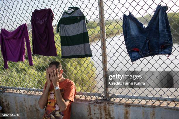 Cuban man waits on the Mexican side of the Brownsville & Matamoros International Bridge where he and others have been waiting for days after being...