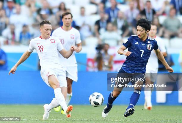 Piotr Zielinski of Poland competes with Gaku Shibasaki of Japan during the 2018 FIFA World Cup Russia group H match between Japan and Poland at...