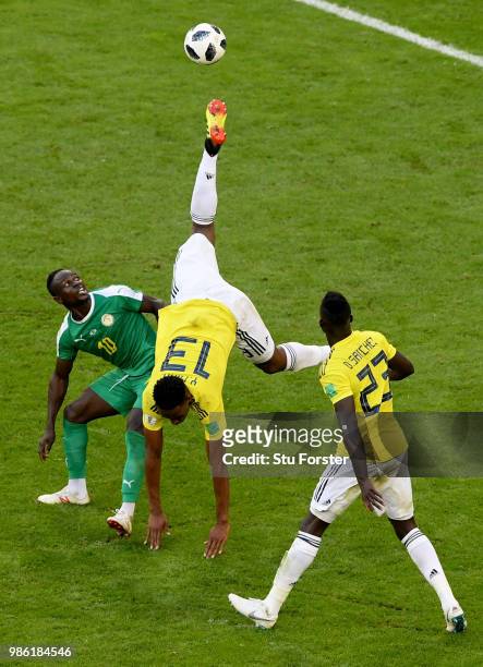 Yerry Mina of Colombia goes airborne under a challenge from Sadio Mane of Senegal as Davinson Sanchez looks on during the 2018 FIFA World Cup Russia...