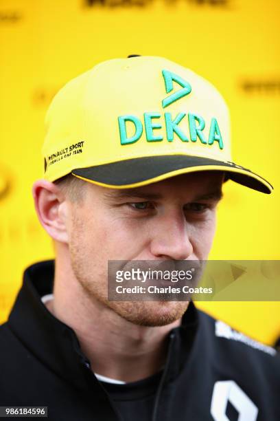 Nico Hulkenberg of Germany and Renault Sport F1 talks to the media in the Paddock during previews ahead of the Formula One Grand Prix of Austria at...