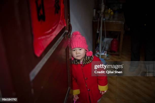 Zhao Jing stands by the door to her apartment in the Wujianong neighborhood of Hefei, China, on Thursday, Nov. 26, 2015. Cheap housing in the...