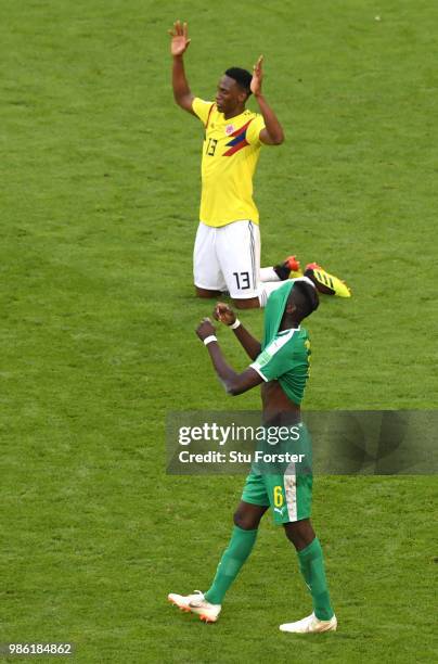 Salif Sane of Senegal looks dejected as Yerry Mina of Colombia celebrates following his sides victory in the 2018 FIFA World Cup Russia group H match...