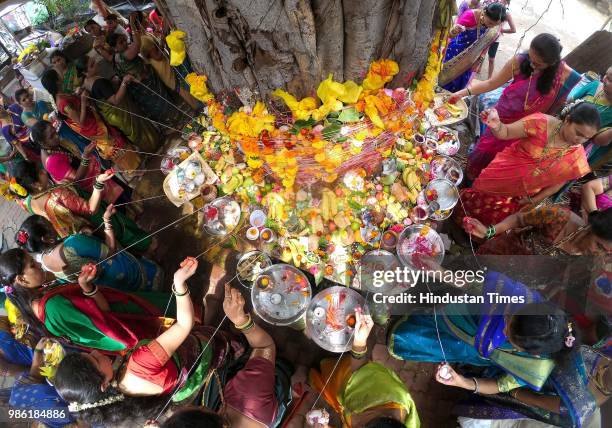 Married women of Koliwada, Badhwar Park tying threads and performing puja around the Banyan tree on the occasion of Vat Purnima, on June 27, 2018 in...
