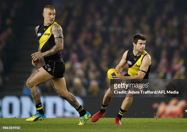 Trent Cotchin of the Tigers in action ahead of Dustin Martin of the Tigers during the 2018 AFL round 15 match between the Richmond Tigers and the...