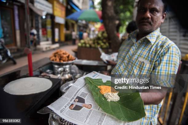 Dosa stall owners using paper bag after plastic ban at Dadar, on June 27, 2018 in Mumbai, India. On March 23, the state government imposed a ban on...