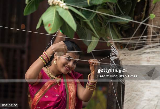 Hindu women tying threads and performing puja around the Banyan tree on the occasion of Vat Purnima at Dadar, on June 27, 2018 in Mumbai, India....