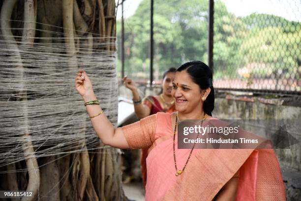 Hindu women tying threads and performing puja around the Banyan tree in Omkareshwar Temple on the occasion of Vat Purnima, on June 27, 2018 in Pune,...