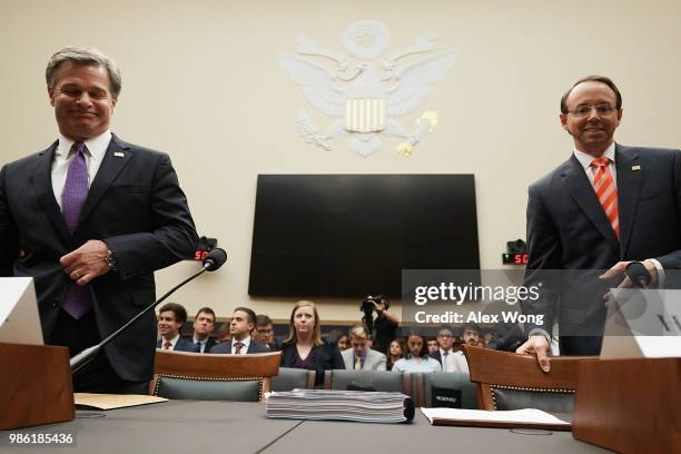 Deputy Attorney General Rod Rosenstein and FBI Director Christopher Wray take their seats during a hearing before the House Judiciary Committee June...