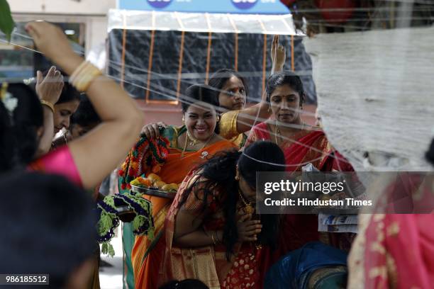 Hindu women tying threads and performing puja around the Banyan tree on the occasion of Vat Purnima at Warje Madwadi, on June 27, 2018 in Pune,...