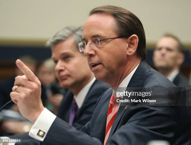 Deputy Attorney General Rod Rosenstein and FBI Director Christopher Wray testify during a House Judiciary Committee hearing June 28, 2018 on Capitol...