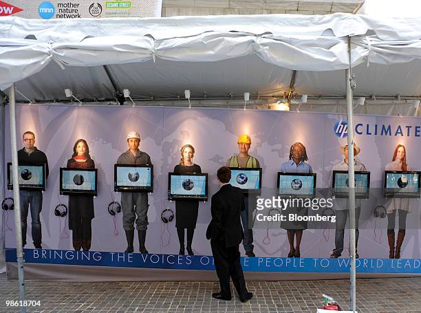 Man looks at a Hewlett-Packard Co. Display set up for Earth Day in front of the New York Stock Exchange in New York, U.S. Thursday, April 22, 2010....