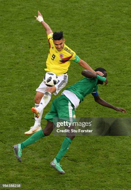 Radamel Falcao of Colombia and Cheikhou Kouyate of Senegal compete in the air for the ball during the 2018 FIFA World Cup Russia group H match...