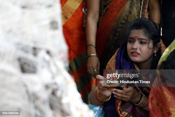 Hindu women tying threads and performing puja around the Banyan tree on the occasion of Vat Purnima at Warje Madwadi, on June 27, 2018 in Pune,...