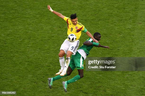 Radamel Falcao of Colombia and Cheikhou Kouyate of Senegal compete in the air for the ball during the 2018 FIFA World Cup Russia group H match...