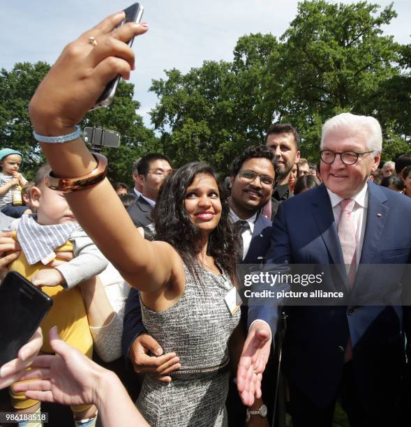 June 2018, Germany, Berlin: German President Frank-Walter Steinmeier speaking with guests during a reception for around 600 fellowship holders of the...