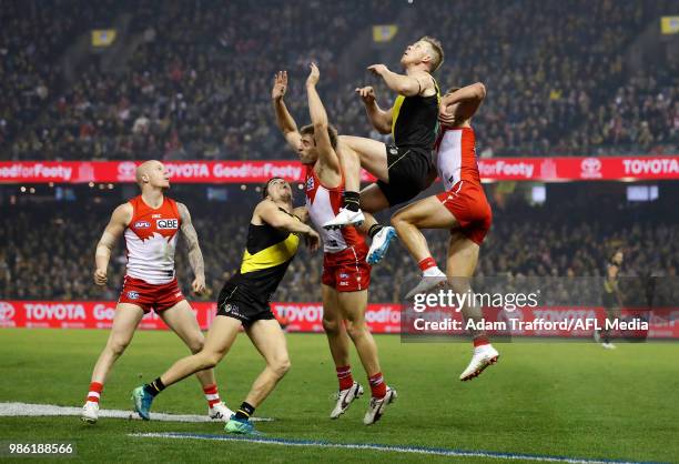 Jack Riewoldt of the Tigers marks the ball over Nick Smith and Dane Rampe of the Swans and Jason Castagna of the Tigers during the 2018 AFL round 15...