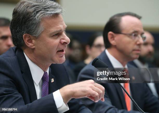 Director Christopher Wray and U.S. Deputy Attorney General Rod Rosenstein testify during a House Judiciary Committee hearing June 28, 2018 on Capitol...