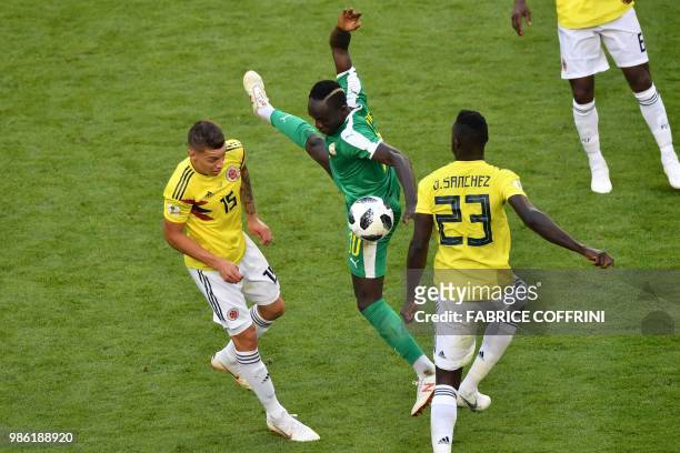 Senegal's forward Sadio Mane vies for the ball with Colombia's midfielder Mateus Uribe and Colombia's defender Davinson Sanchez during the Russia...