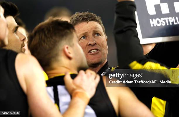 Damien Hardwick, Senior Coach of the Tigers addresses his players during the 2018 AFL round 15 match between the Richmond Tigers and the Sydney Swans...