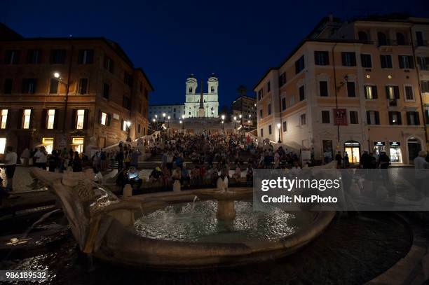 Piazza di Spagna with the Fontana della Barcaccia and in the background the monumental stairway of 136 steps of Trinità dei Monti that connects to...