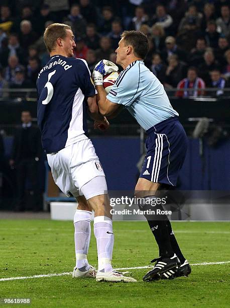 Goalkeeper Frank Rost of HSV saves the ball against Brede Hangeland of Fulham during the UEFA Europa League semi final first leg match between...