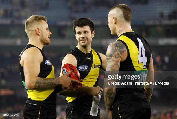 Trent Cotchin of the Tigers celebrates with Brandon Ellis and Dustin Martin of the Tigers during the 2018 AFL round 15 match between the Richmond...