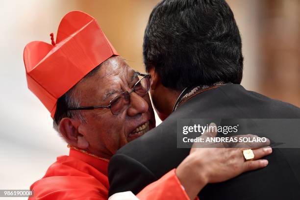 Newly appointed Cardinal Bolivian Toribio Ticona Porco prelate emeritus of Corocoro hugs Bolivian President Evo Morales after a consistory lead by...