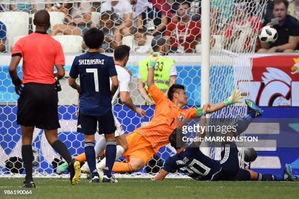 Japan's goalkeeper Eiji Kawashima dives during the Russia 2018 World Cup Group H football match between Japan and Poland at the Volgograd Arena in...