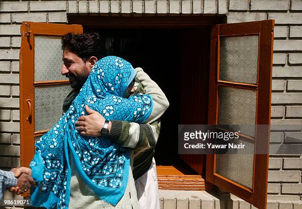 Mohammad Maqbool Shah hugs a relative after being acquitted by a session court in India's capital New Delhi at his home on April 22, 2010 in...