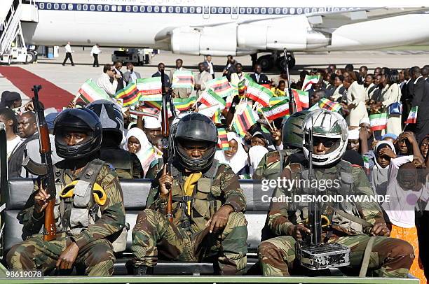 Zimbabwean soilders protect Iranian President Mahmoud Ahmadinejad soon after his arrival at Harare international Airport on April 22, 2010 The...