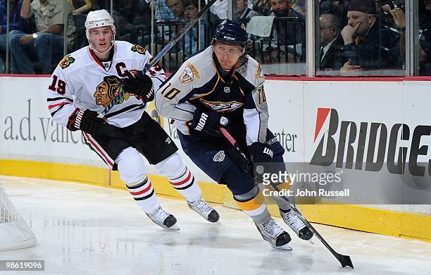 Martin Erat of the Nashville Predators skates against Jonathan Toews of the Chicago Blackhawks in Game Three of the Western Conference Quarterfinals...