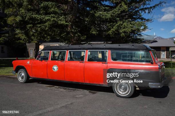 Red stretch limo is parked at the entrance to the Glacier Park Lodge on June 20 in East Glacier, Montana. Home to Glacier National Park, St. Mary,...