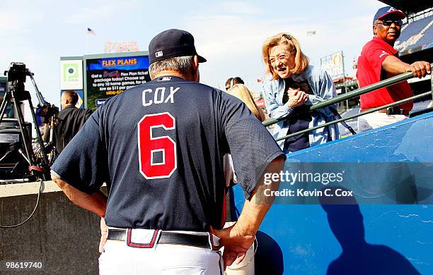 Manager Bobby Cox of the Atlanta Braves talks to a fan at the end of the dugout during batting practice before facing the Philiadelphia Phillies at...