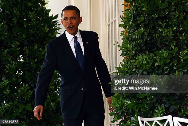 President Barack Obama walks from the Oval Office to a reception marking Earth Day in the Rose Garden of the White House April 22, 2010 in...