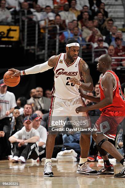 LeBron James of the Cleveland Cavaliers handles the ball against Luol Deng of the Chicago Bulls in Game Two of the Eastern Conference Quarterfinals...