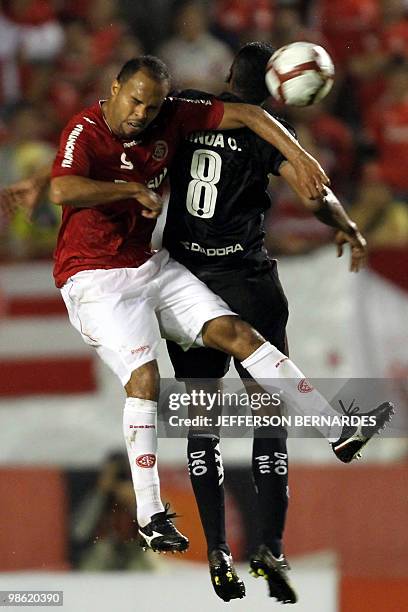 Deportivo Quito's Tilson Minda vies for the ball with Internacional's Alecsandro during their Libertadores Cup football match at Beira Rio Stadium in...