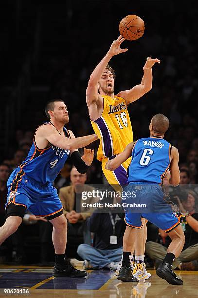 Pau Gasol of the Los Angeles Lakers passes against Nick Collison and Eric Maynor of the Oklahoma City Thunder in Game Two of the Western Conference...