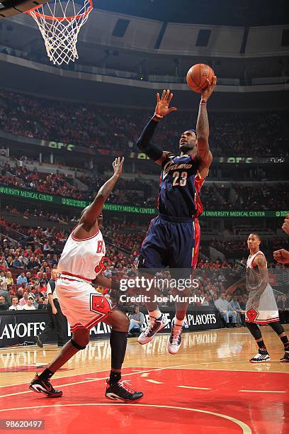 Lebron James of the Cleveland Cavaliers goes to the basket over Luol Deng of the Chicago Bulls in Game Three of the Eastern Conference Quarterfinals...