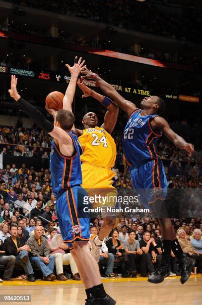 Kobe Bryant of the Los Angeles Lakers shoots against Nick Collison and Jeff Green of the Oklahoma City Thunder in Game Two of the Western Conference...