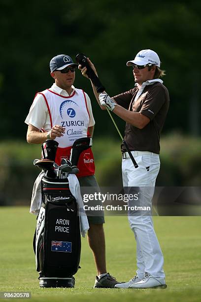 Aron Price of Australia pulls a club from his bag on the 12th fairway during the first round of the Zurich Classic at TPC Louisiana on April 22, 2010...