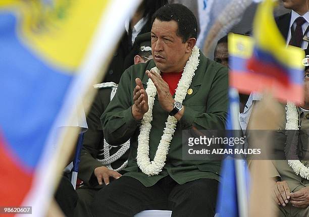 Venezuelan President Hugo Chavez applauds during a World Climate Change Conference at the Feliz Capriles stadium in Cochabamba, Bolivia on April 22,...