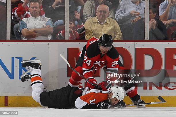 Ian Laperriere of the Philadelphia Flyers goes to the ice while skating against Bryce Salvador of the New Jersey Devils in Game 5 of the Eastern...