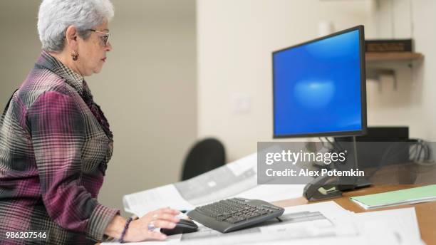 mujer de pelo plateado senior, ingeniero, trabajando con el proyecto arquitectónico - alex potemkin or krakozawr fotografías e imágenes de stock