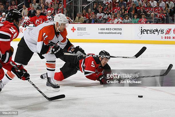 Blair Betts of the Philadelphia Flyers and Colin White of the New Jersey Devils go after the loose puck in Game 5 of the Eastern Conference...