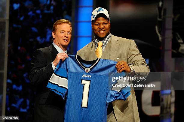 Ndamukong Suh of the Nebraska Cornhuskers stands with NFL Commissioner Roger Goodell as he holds up a Detroit Lions Jersey after Suh was picked...