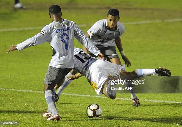 Uruguay's Cerro player Claudio Dadomo vies for the ball with Ecuador's Emelec players Silvano Estacio and Javier Morantes during their Libertadores...