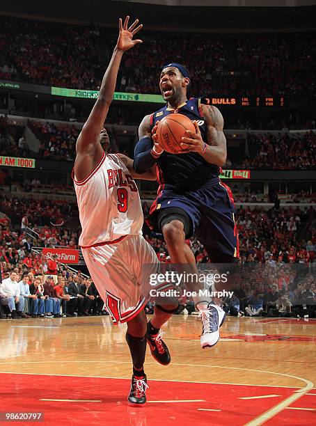 Lebron James of the Cleveland Cavaliers goes to the basket past Luol Deng of the Chicago Bulls in Game Three of the Eastern Conference Quarterfinals...