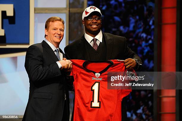 Gerald McCoy of the Oklahoma Sooners poses with NFL Commissioner Roger Goodell as he holds a Tampa Bay Buccaneers jersey after he was picked third...